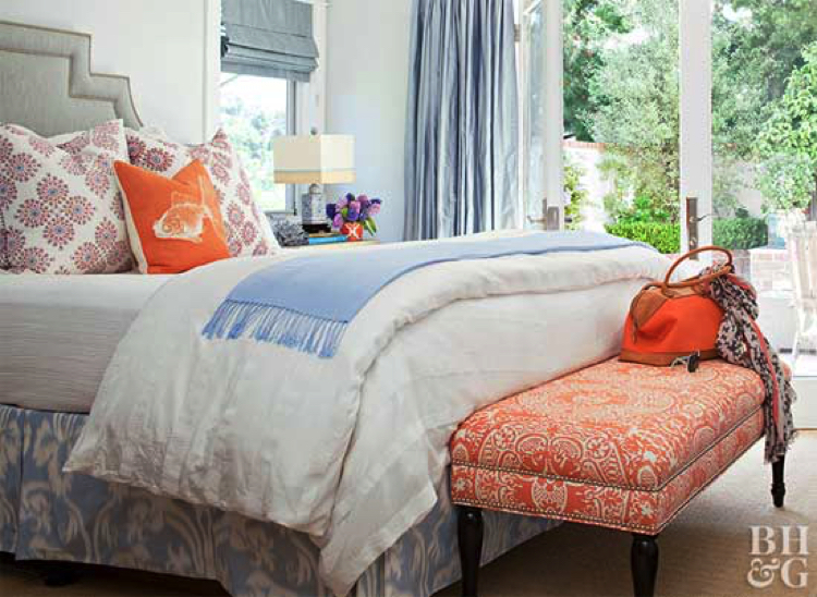 Subtle splash of orange over a bed