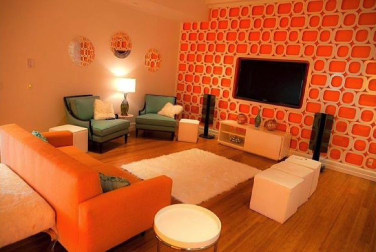 Classic furnishings and an elegant suite are made alive with brave orange wall accents, a truly lively living room.