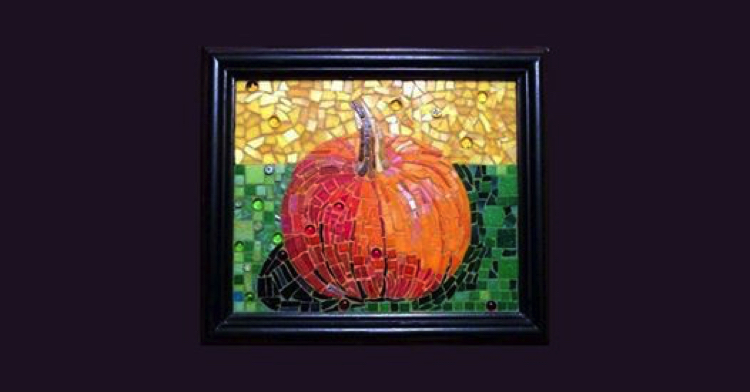 A framed picture of a Halloween mosaic design of a pumpkin