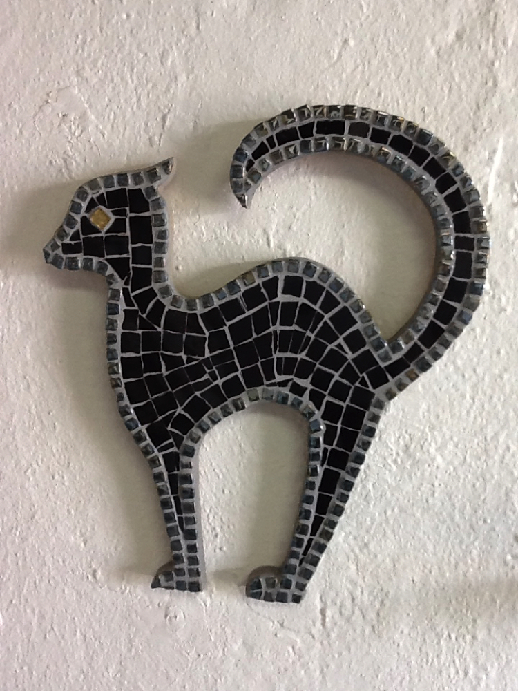 A Halloween mosaic design of a black cat