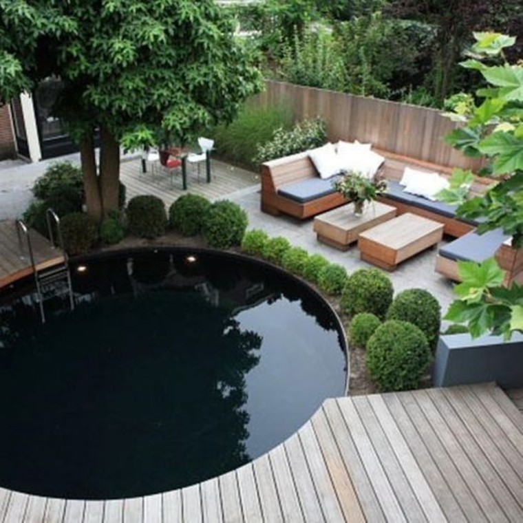 Round pool with dark mosaic tiles.